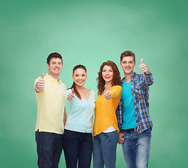 Image showing group of smiling teenagers over green board