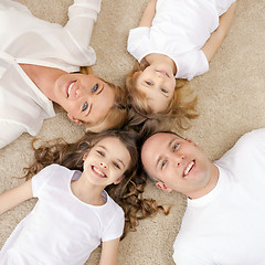 Image showing parents and two girls lying on floor at home