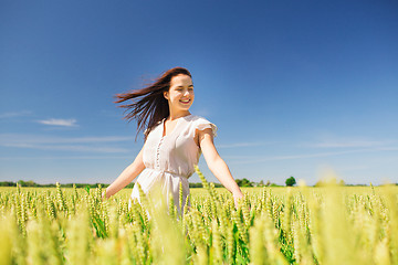 Image showing smiling young woman on cereal field