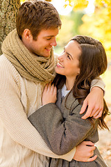 Image showing smiling couple hugging in autumn park