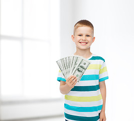 Image showing smiling boy holding dollar cash money in his hand