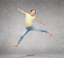 Image showing smiling little girl jumping