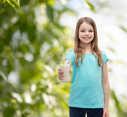 Image showing smiling little girl giving glass of milk