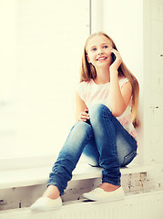 Image showing girl with smartphone at school