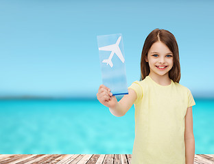 Image showing smiling little girl with airplane ticket