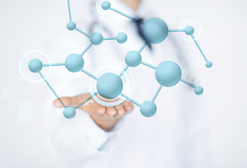 Image showing close up of male doctor hand with molecules