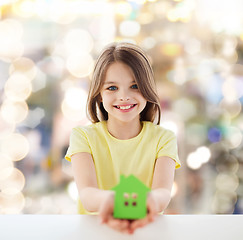 Image showing beautiful little girl holding paper house cutout