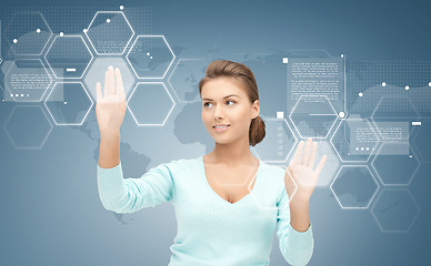 Image showing smiling businesswoman working with virtual screen