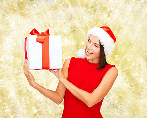 Image showing smiling woman in red dress with gift box