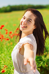 Image showing laughing young woman on poppy field