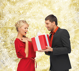 Image showing smiling man and woman with present