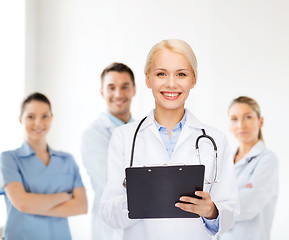 Image showing smiling female doctor with clipboard