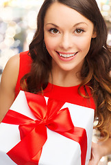 Image showing close up of smiling woman with gift box