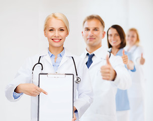 Image showing smiling female doctor with clipboard