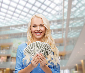 Image showing smiling young woman with us dollar money