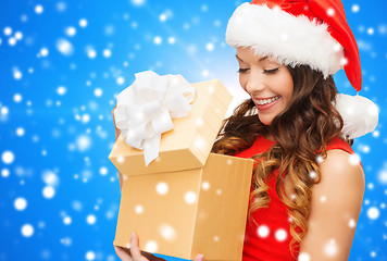 Image showing smiling woman in red dress with gift box