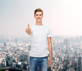 Image showing smiling man in white t-shirt showing thumbs up