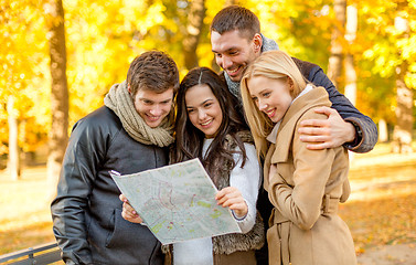 Image showing group of friends with map outdoors