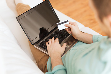 Image showing close up of man with laptop and credit card