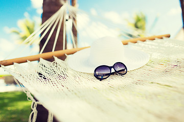 Image showing picture of hammock with white hat and sunglasses