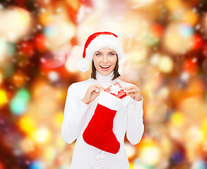 Image showing woman in santa hat with gift box and stocking