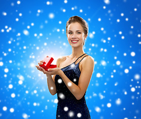 Image showing smiling woman holding red gift box