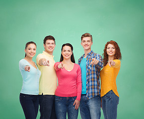 Image showing group of smiling teenagers over green board