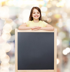 Image showing happy little girl with blank blackboard