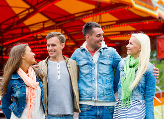 Image showing group of smiling friends in amusement park