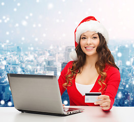 Image showing smiling woman with credit card and laptop