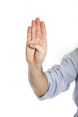 Image showing Man in a blue shirt shows four fingers