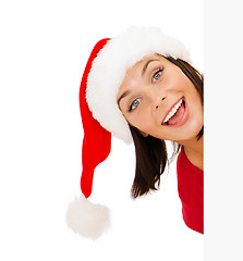 Image showing woman in santa helper hat with blank white board