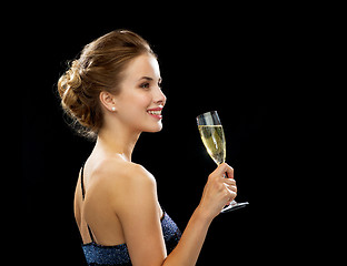 Image showing smiling woman holding glass of sparkling wine