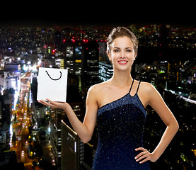 Image showing smiling woman with white blank shopping bag