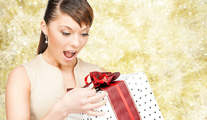 Image showing smiling woman in red dress with gift box