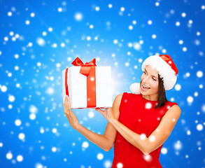 Image showing smiling woman in red dress with gift box