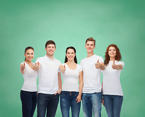 Image showing smiling teenagers in t-shirts showing thumbs up