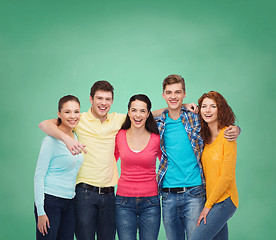 Image showing group of smiling teenagers over green board