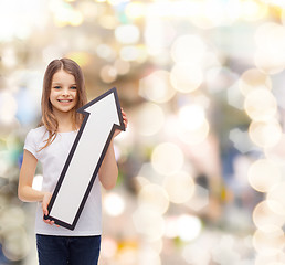 Image showing smiling little girl with blank arrow pointing up