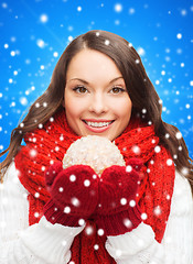 Image showing smiling woman in winter clothes with snowball