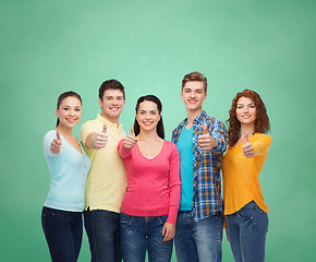 Image showing group of smiling teenagers over green board