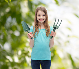 Image showing smiling little girl with rake and scoop