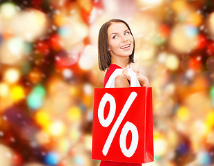 Image showing woman in red dress with shopping bags