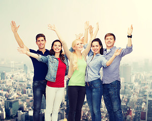 Image showing group of smiling students waving hands