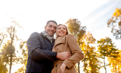 Image showing smiling couple hugging in autumn park