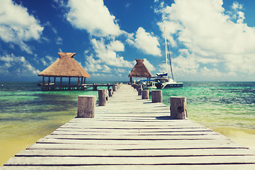 Image showing wooden pier with blue water around