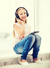 Image showing girl with tablet pc and headphones at home