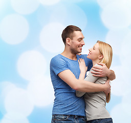 Image showing smiling couple hugging and looking at each other