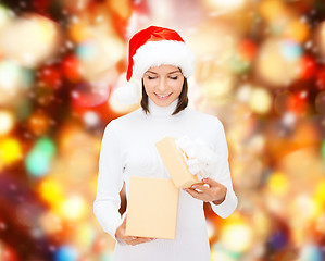 Image showing smiling woman in santa helper hat with gift box