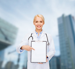 Image showing smiling female doctor with clipboard